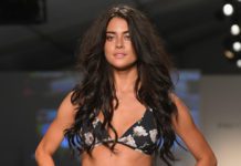 MIAMI, FL - JULY 21: A model walks the runway during the SWIMMIAMI Prey Swim by Audrina Patridge Resort 2018 Collection fashion show at The Tent on July 21, 2017 in Miami, Florida. (Photo by Rodrigo Varela/Getty Images for Prey Swim By Audrina Patridge)