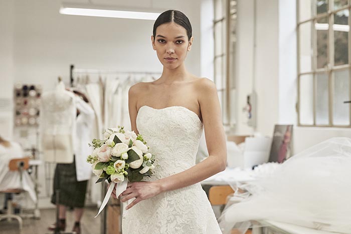 A sleeveless and laced white dress found in the Peter Langner Milano Spring 2023 bridal collection presented at the NYFW: Bridal Spring/Summer 2023